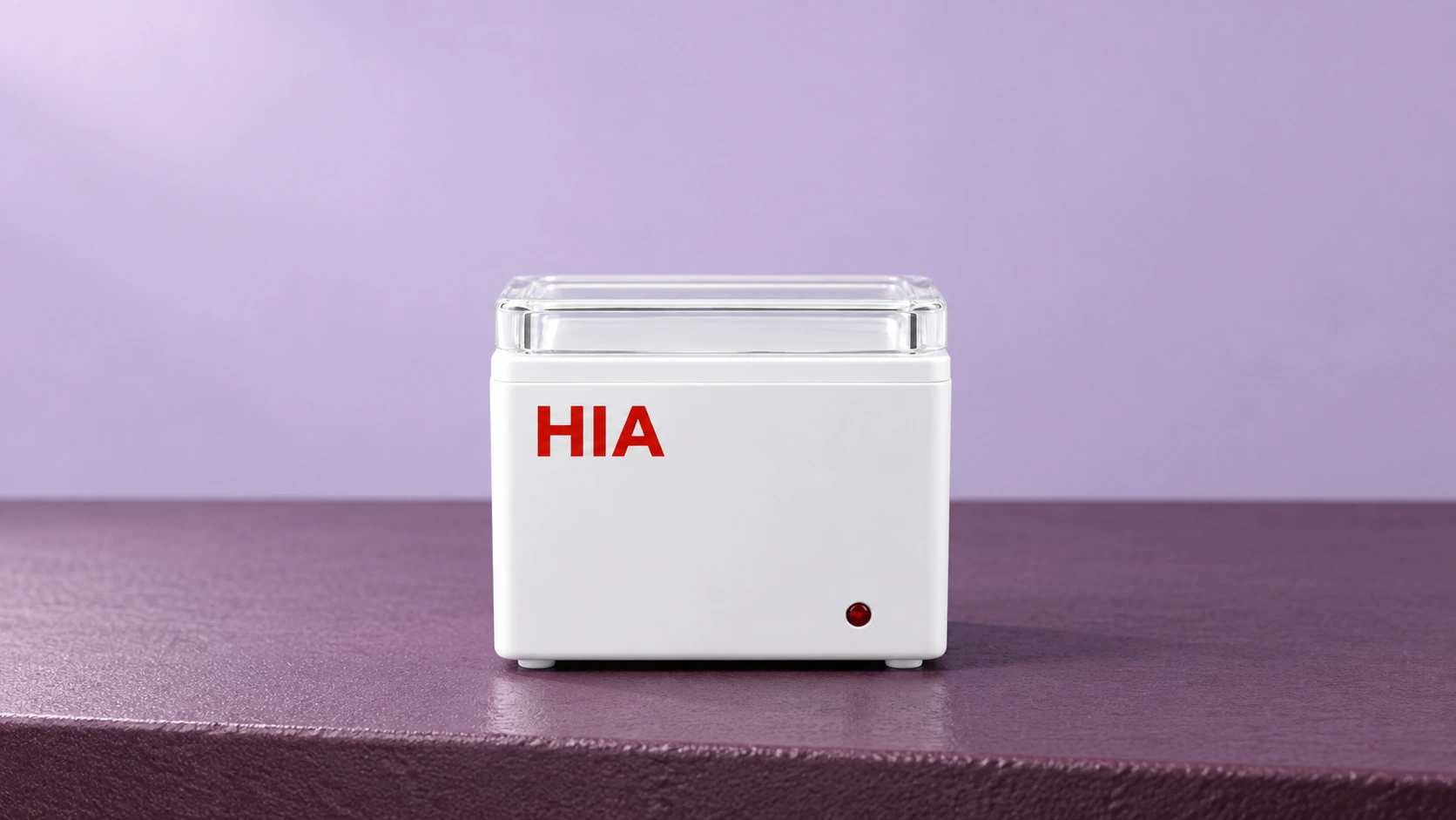 White HIA wax warmer with a clear lid on a plum surface
