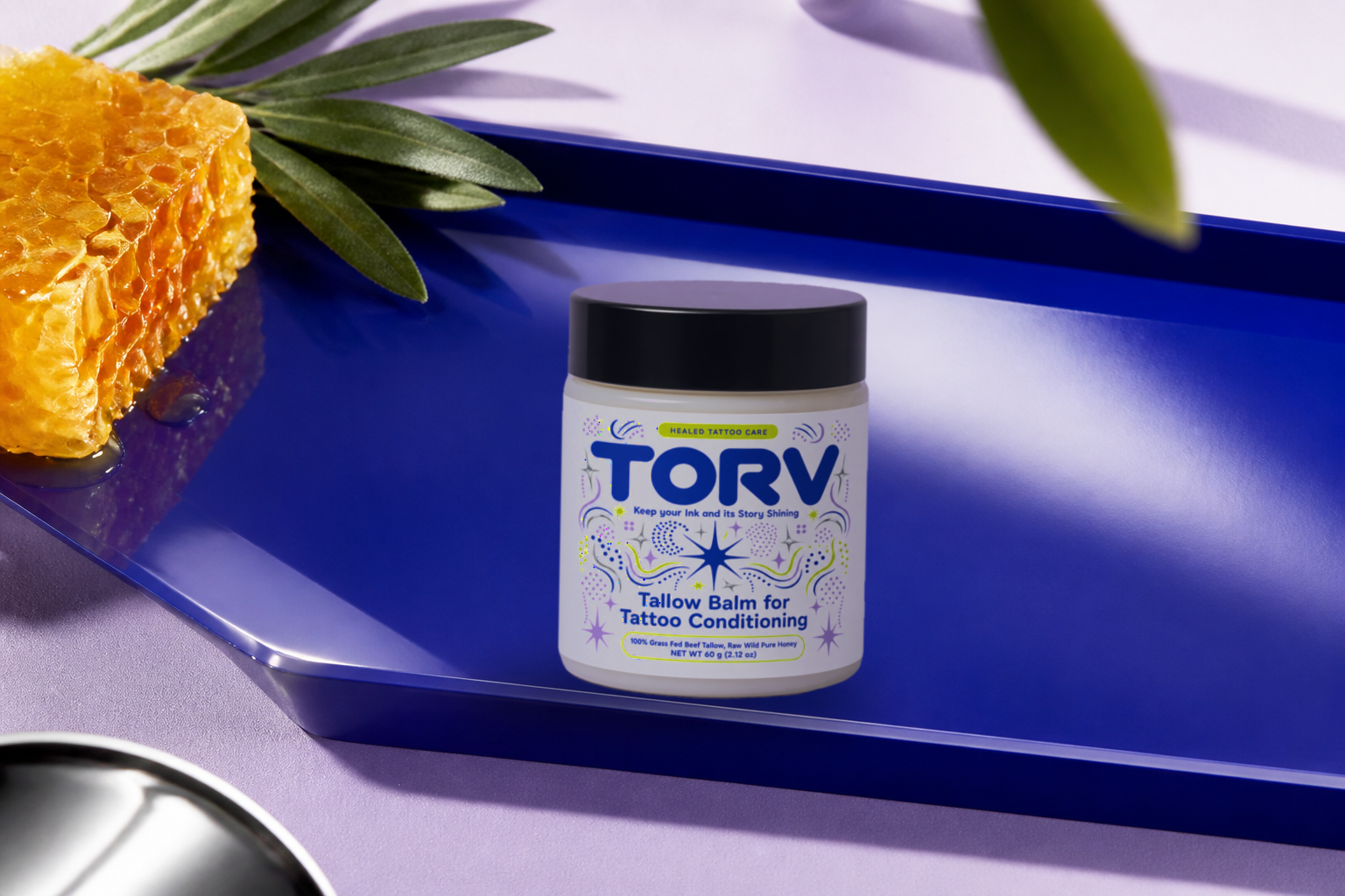 TORV tallow balm shown with healed, tattooed skin