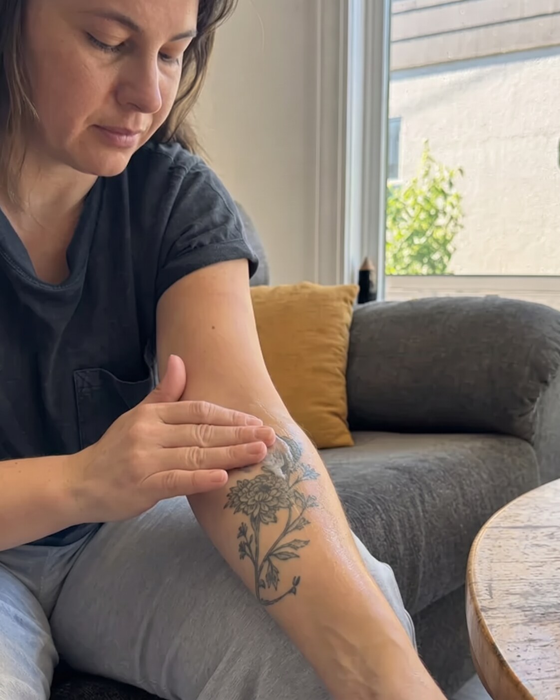 Rubbing TORV balm into a healed tattoo