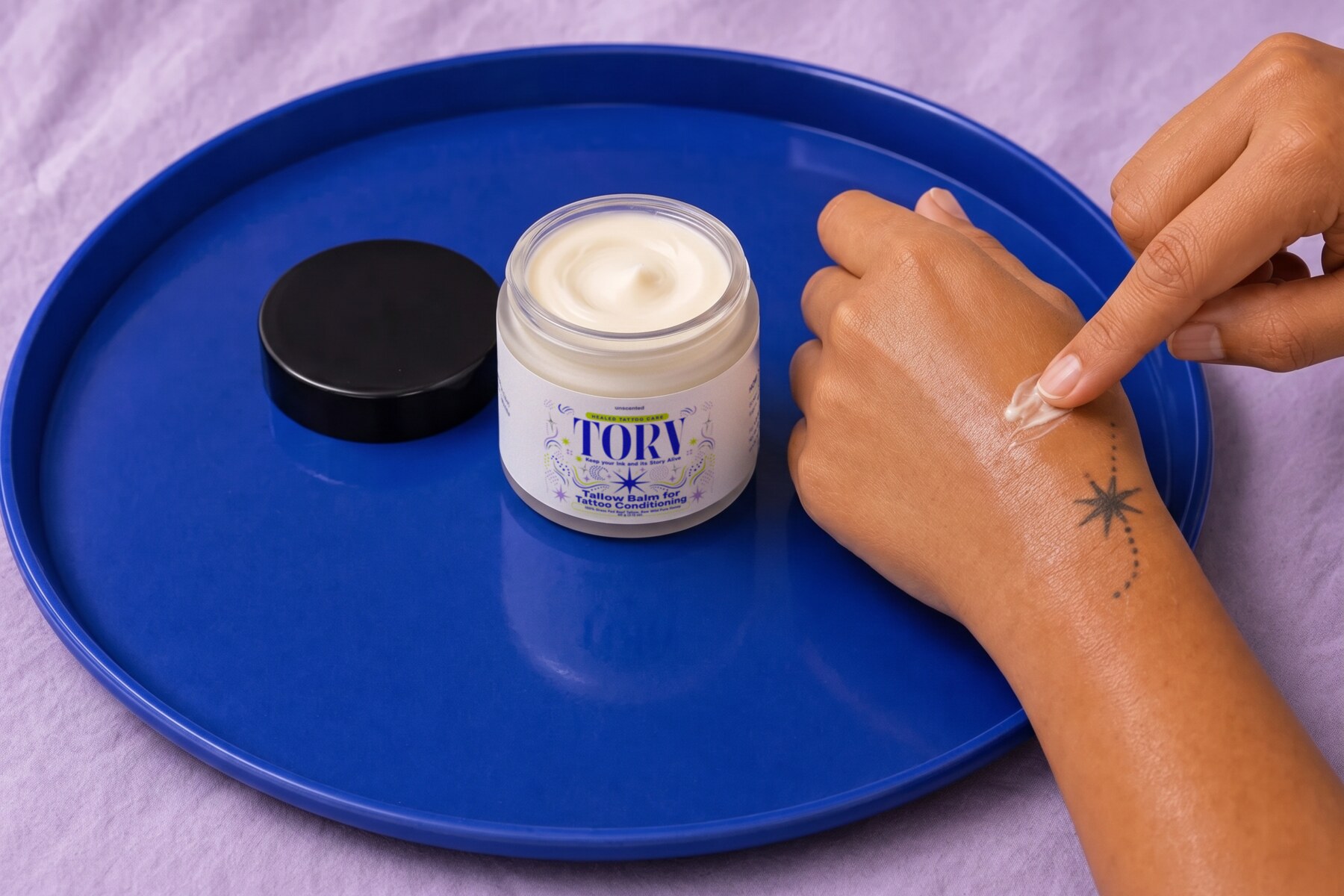 TORV tallow balm shown with healed, tattooed skin
